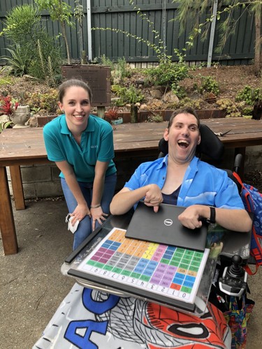 GIVIT engagement officer with a laptop donation recipient